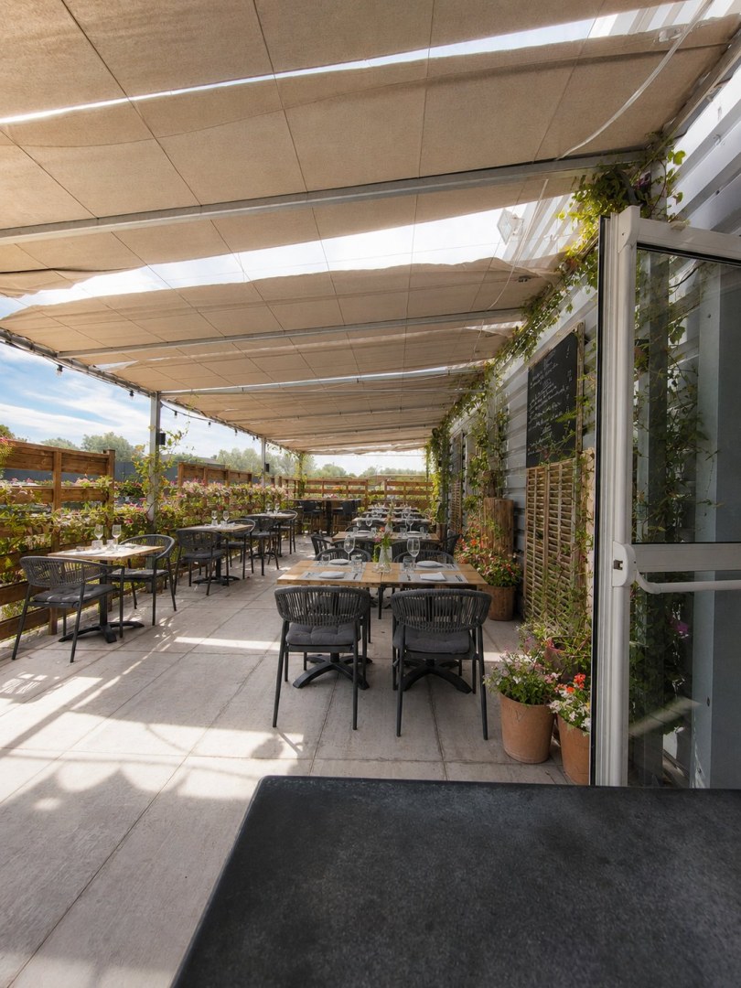 Terrasse végétalisée et ensoleillée du restaurant Hibiscus à Saint-Cannat, avec vue sur le jardin provençal